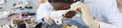 Engineer inspecting computer parts in a quality control lab.