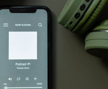 Smartphone playing a podcast with headphones