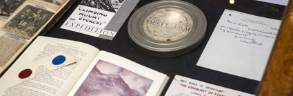 Display of historic materials including film reel, books, and advertisements