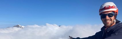 Felix de Montety above the clouds atop a mountain