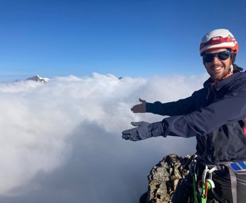 Felix de Montety above the clouds atop a mountain