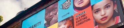 Unicef billboard that reads "Humanity needs humanity" with pictures of children