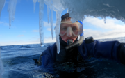Phoebe Smith taking a selfie while ice snorkelling in the ocean.