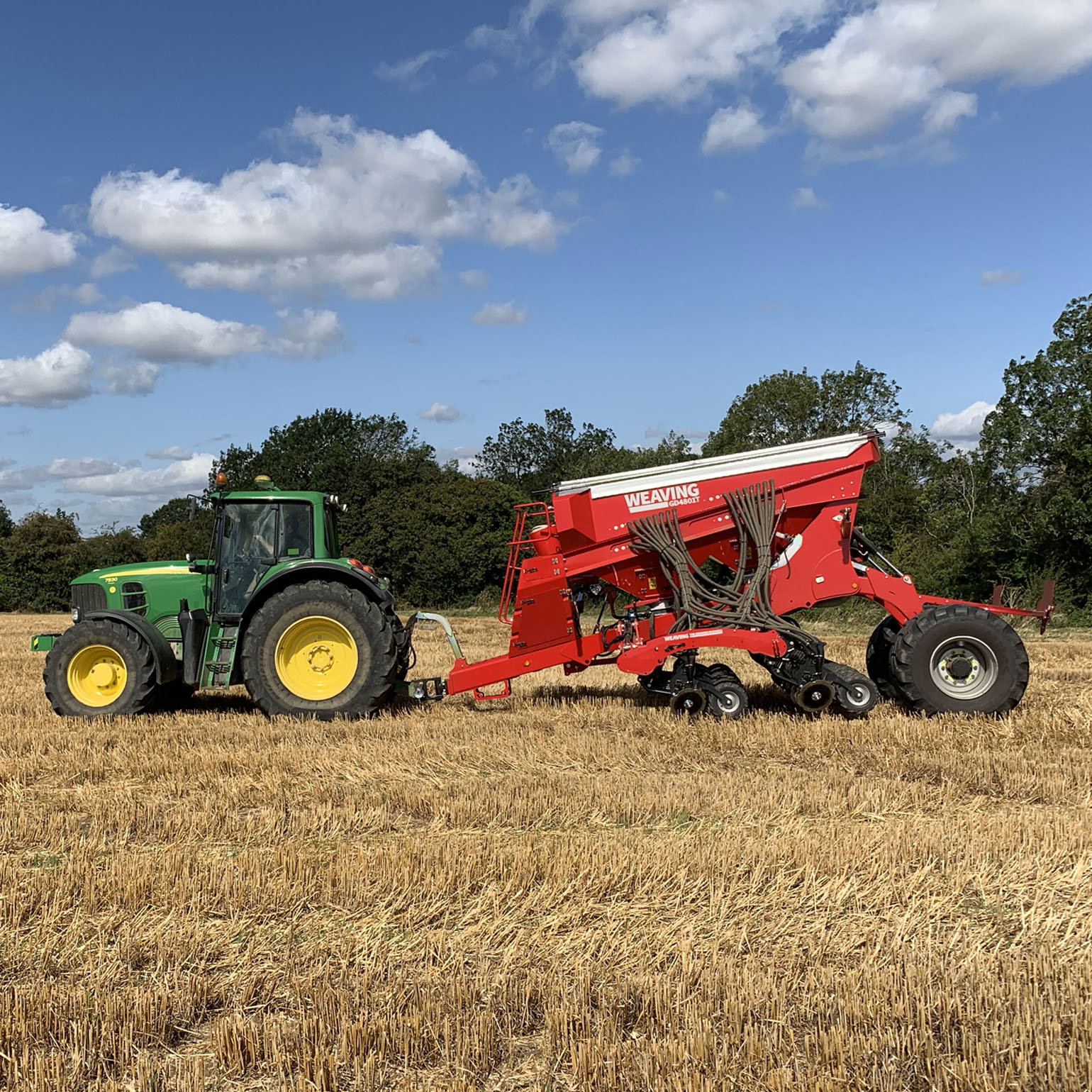 A tractor pulling a plogh through a field