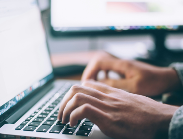 Person Typing On Macbook