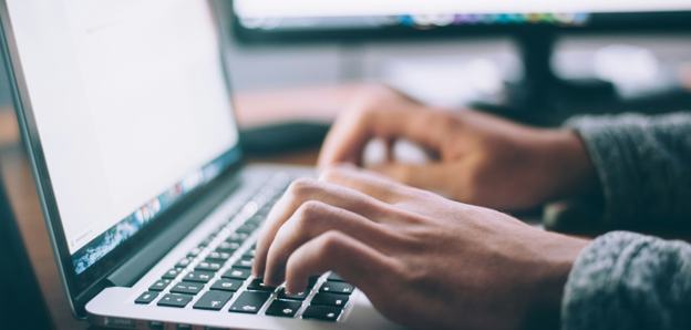 Person Typing On Macbook