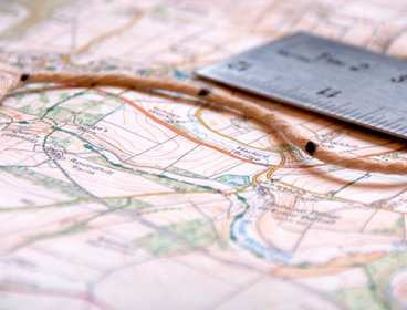 Map, ruler and string