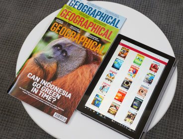 Tablet with geographical covers displayed with print copies next to it.