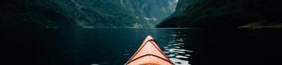 Kayak among steep valley sides and moody clouds