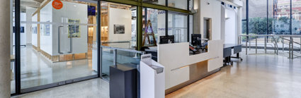 The main hall with reception desk and exhibition pavilion space at the Royal Geographical Society.