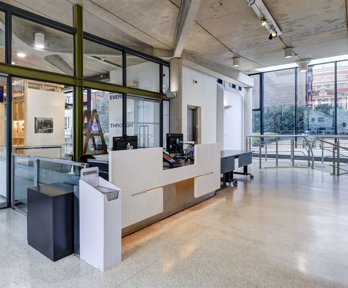 The main hall with reception desk and exhibition pavilion space at the Royal Geographical Society.