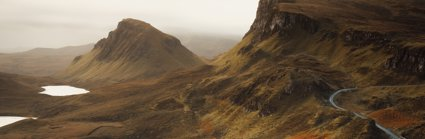 A view over the landscape of the Isle of Skye, showing craggy hills and valleys