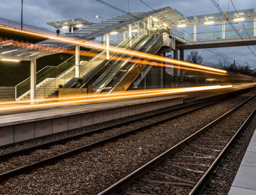 Long exposure photograph of train lights at a train station.