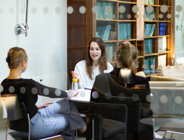 Three people sat in the Members' Room at the Society. They are chatting.