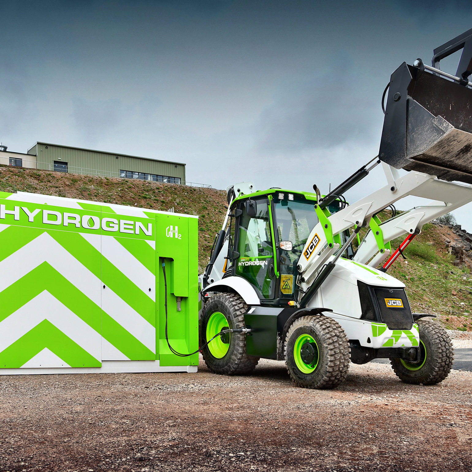 A JCB digger next to a hydrogen fuel cell