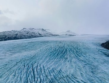 Large ice field with mountains in the background