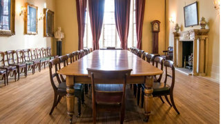 A large wooden table setup for a boardroom meeting in the Council Room at the Society.