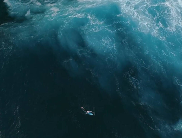 Surfer at sea, from above