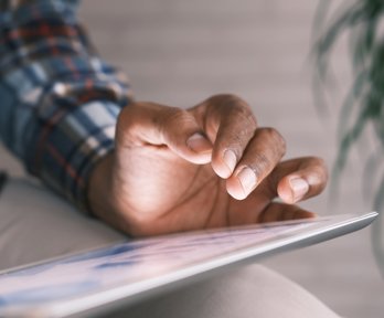 Person typing on a tablet 