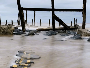 Titled 'end of the road', this artwork shows broken pieces of road going into the sea.