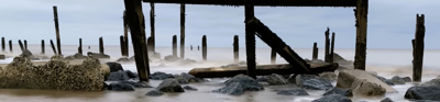 Titled 'end of the road', shows a broken pieces of road going into the sea