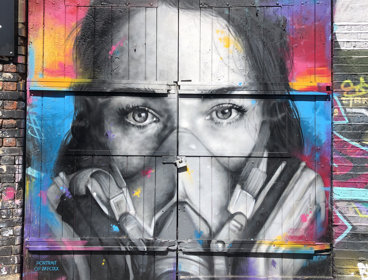 Graffiti of a woman in a face mask