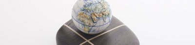 Porcelain globe on top of a dark bog oak.