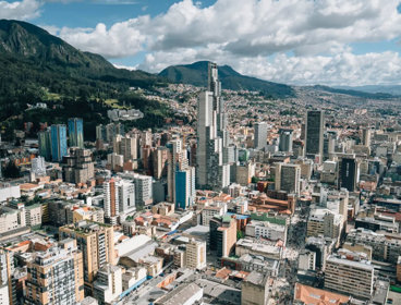 Highrise view of a city, with mountains in the background. 