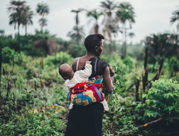 A woman carrying a child on her back