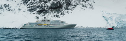 Luxury cruise ship in an arctic region next to a glacier. 