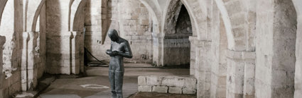 Statue Of Person Holding Bowl In Church