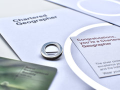 Chartered Geographer silver circle pin, card reading "Congratulations, you're a Chartered Geographer" and 2023 membership card
