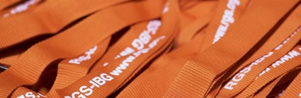 Orange conference lanyards with white lettering reading RGS-IBG