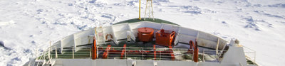 The front of an icebreaker ship, moving through pack ice in Antarctica