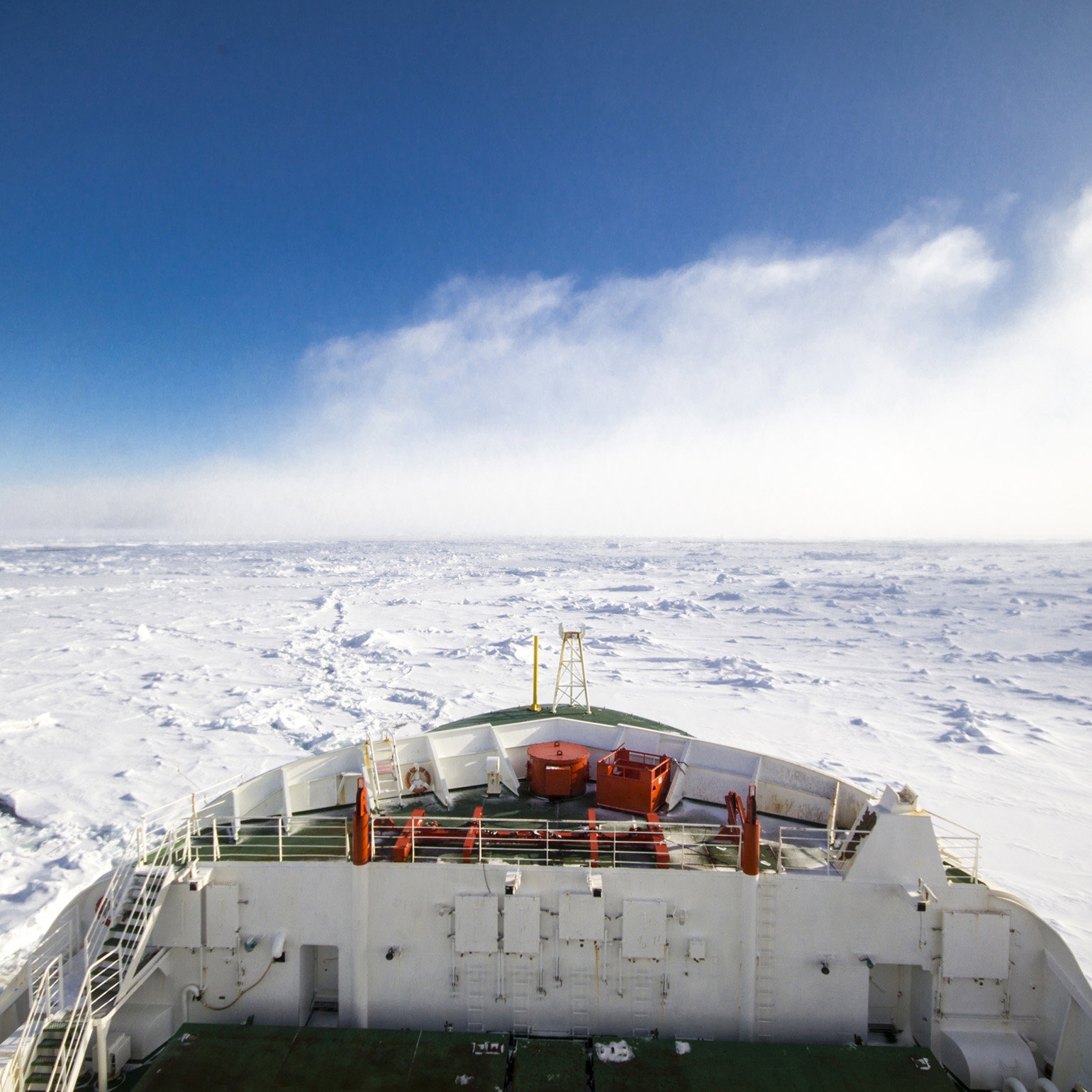 The front of an icebreaker ship, moving through pack ice in Antarctica