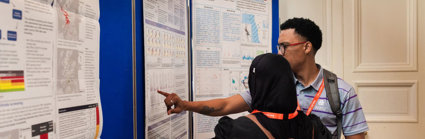 A presenter discussing their poster with another conference attendee.