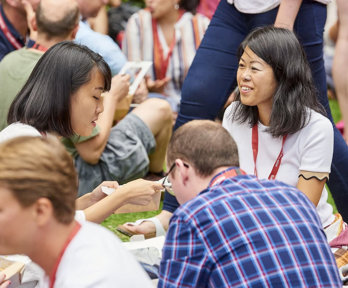 Conference delegates networking over lunch in the garden