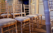 Rows of empty wooden chairs setup for a wedding ceremony.