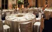 Dinner tables setup for an evening wedding reception in the Education Centre.