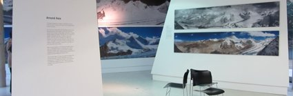 Exhibition boards with text and photographs showing mountain scenes
