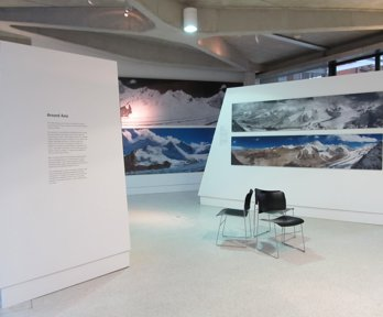 Exhibition boards with text and photographs showing mountain scenes