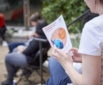 A woman reading a conference programme