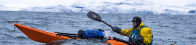 Person in a kayak at sea in Greenland. 