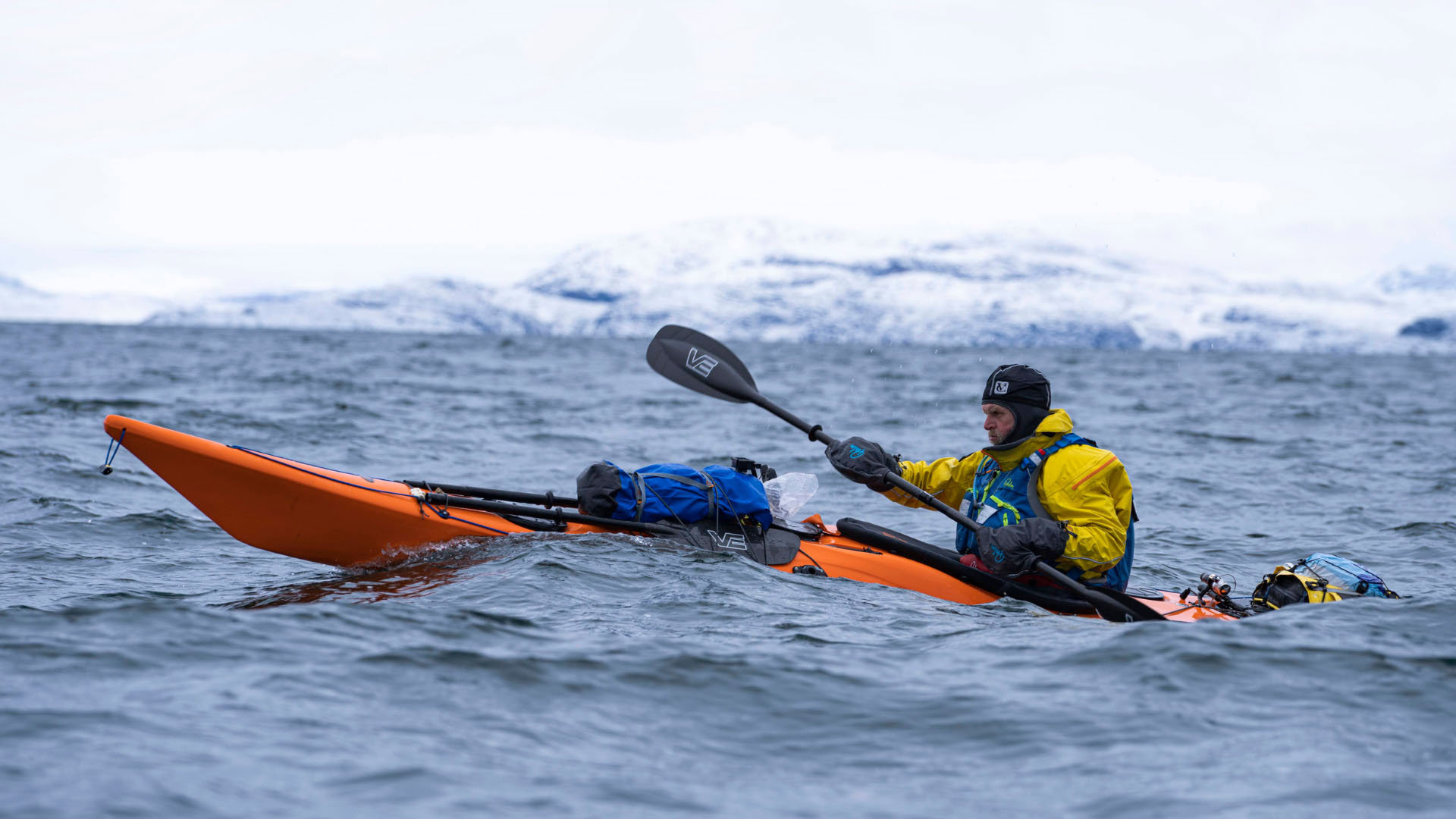 Person in a kayak at sea in Greenland. 