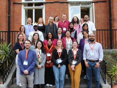 Delegates at the postgraduate mid-term conference 2025, standing on the stairs at the Terrace