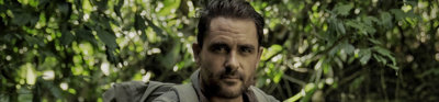 Levison Wood stood in forest in green expedition gear.