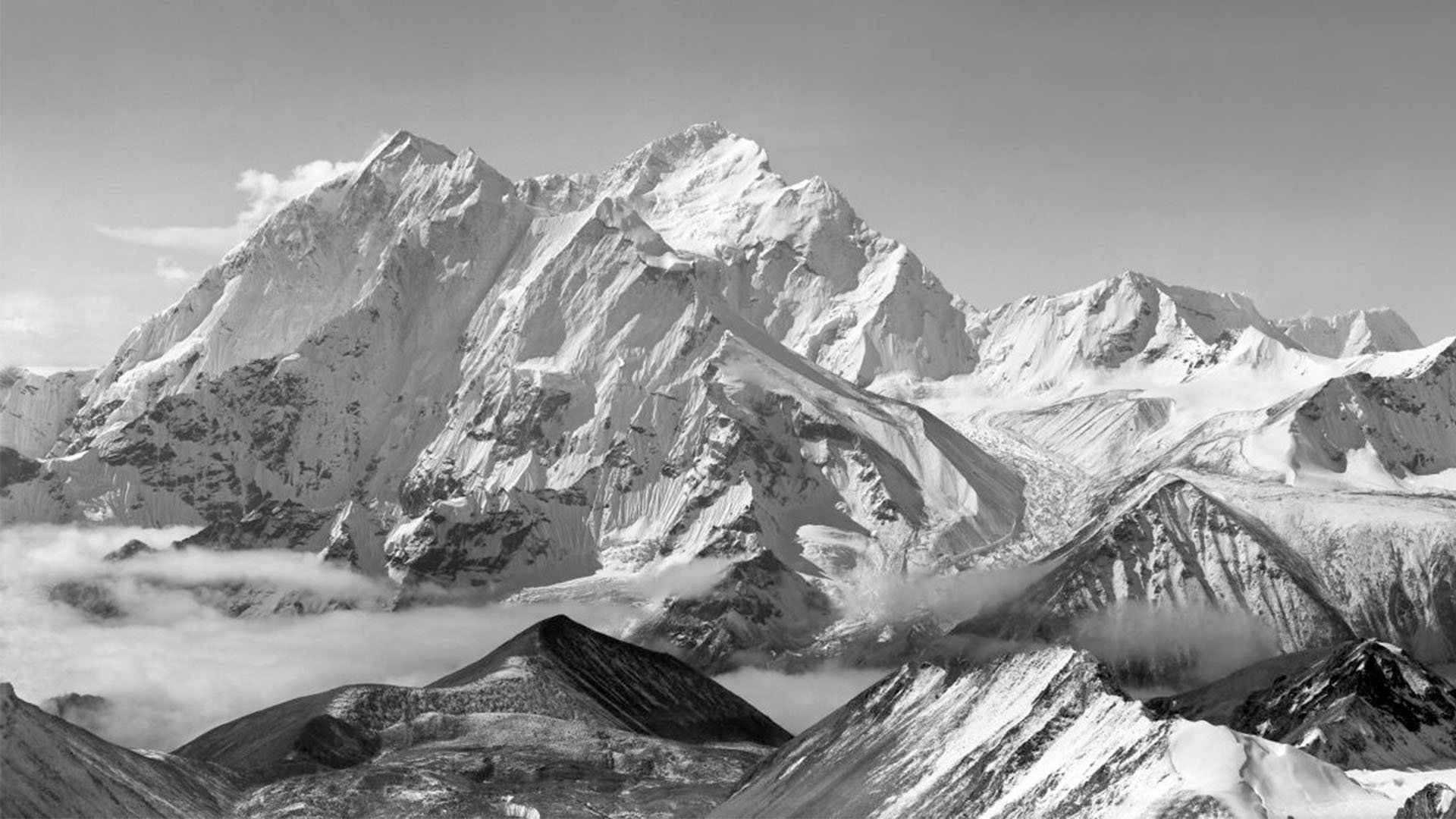 Panoramic view of Mount Everest with snow capped mountains in black and white.