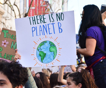 A group of students on a protest, holding a sign saying 'There is no planet B'