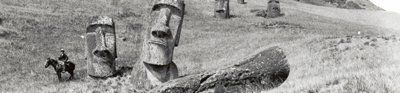 General view of the statues standing within the southern outer slopes of the statue quarry Rano Raraku (Horse and rider for scale), Easter Island, 1913. 