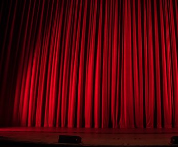 Closed curtains on a theatre stage